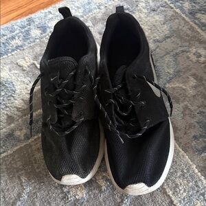 Nike Black Sneakers with White Soles and Silver Swoosh